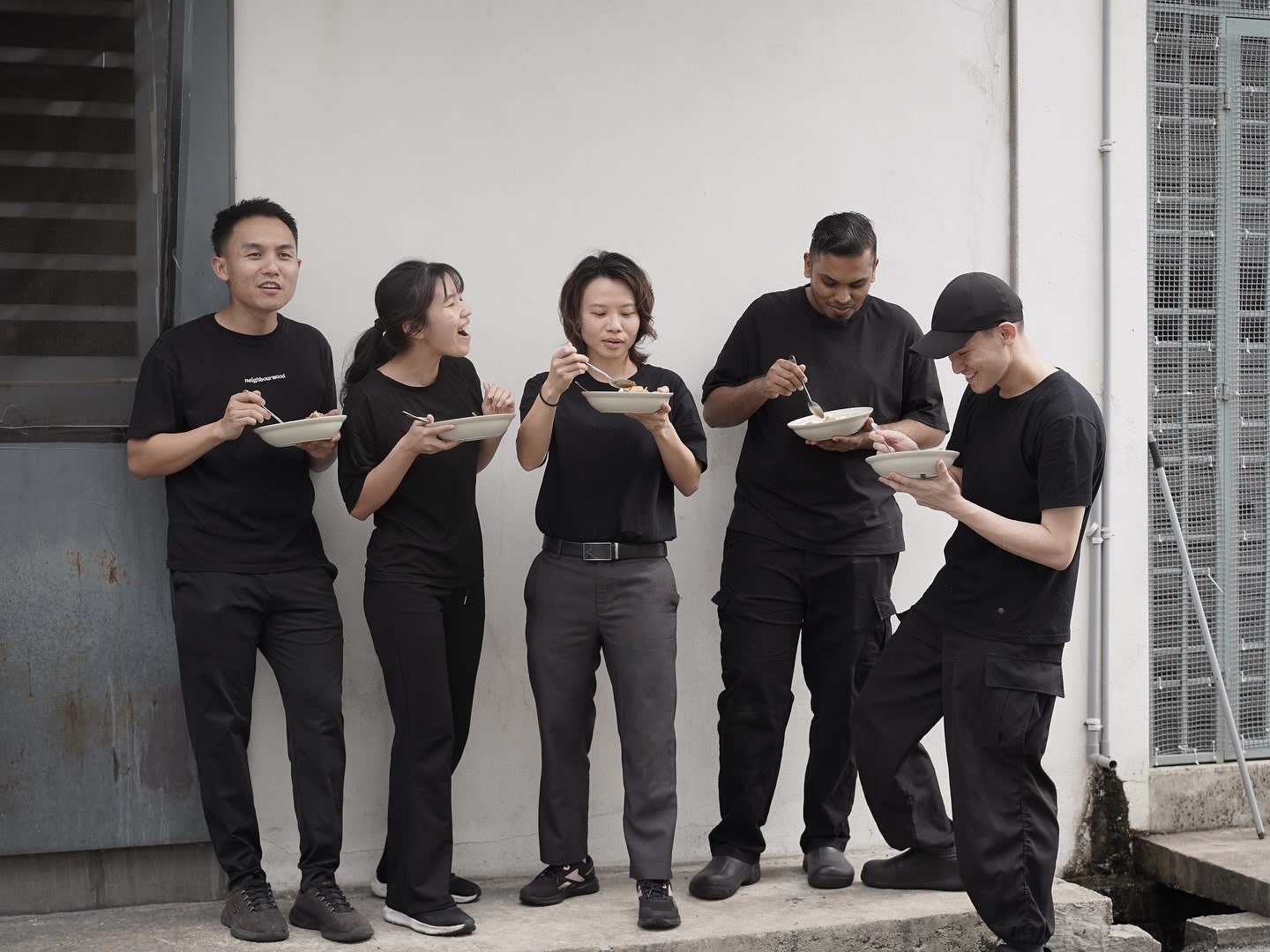 The Neighbourwood team sharing a meal after service
